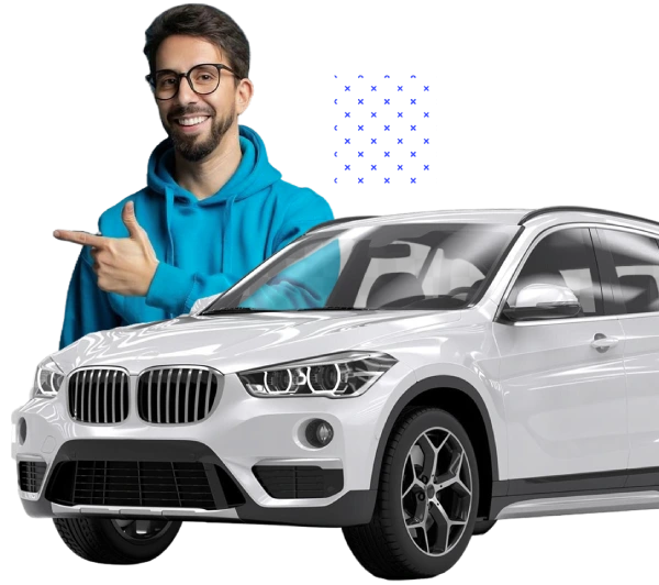 Smiling man pointing at a white SUV